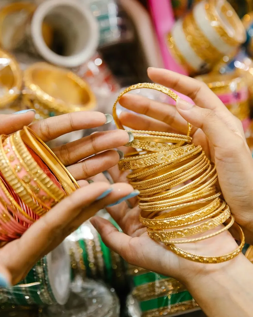 Gold bangles held in hand